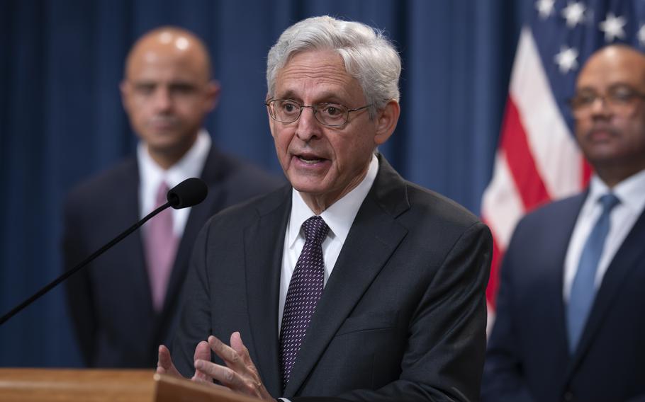 Merrick Garland stands at a podium and speaks during a news conference.