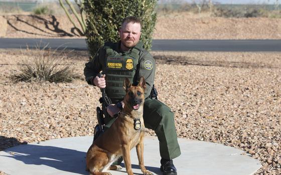 Border Patrol Agent David Maland posing with a service dog. 