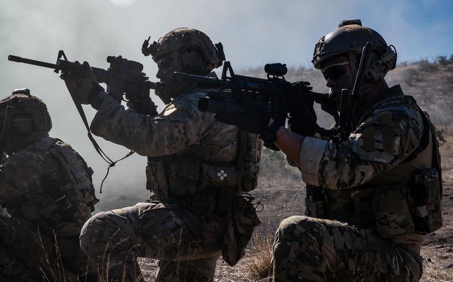 Airmen hold weapons while training in Green Valley, Ariz.