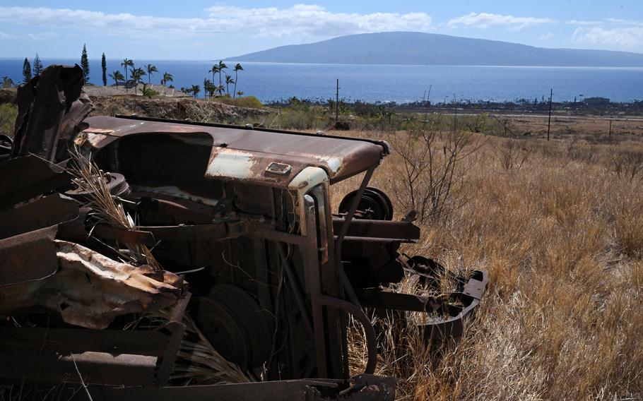 Vehicles from the 2018 fires sit on Samantha Dizon’s property in Lahaina this month. The 2018 fires were driven by high winds, similar to this month’s fire.