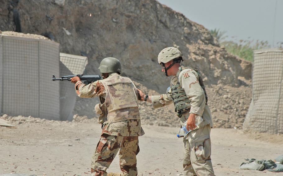 A U.S. soldier works with an Iraqi soldier on marksmanship at Camp Indepedence, Iraq. The Iraqi soldiers have spent more than a month at Independence, learning the basics of being a soldier. In a few weeks, they will go out on their first patrol.