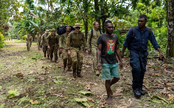 Locals lead a multinational force of service members to unexploded ordnance in Ringgi Cove, Kolombangara, Solomon Islands, Sept. 9, 2024. 
