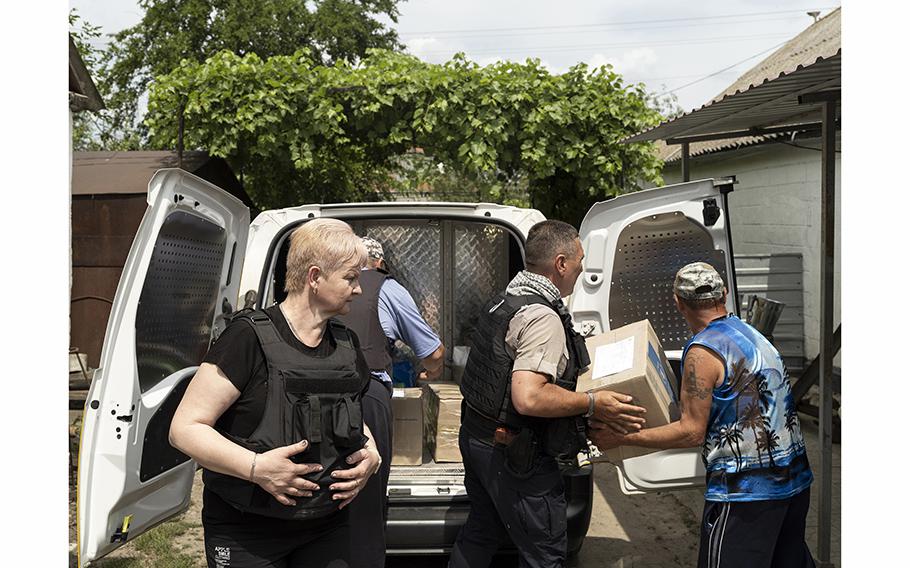 Mail carrier Natalia Hrinenko, foreground, was head of the post office in the town of Hulyaipole, Ukraine, until the building was bombed in May of last year.