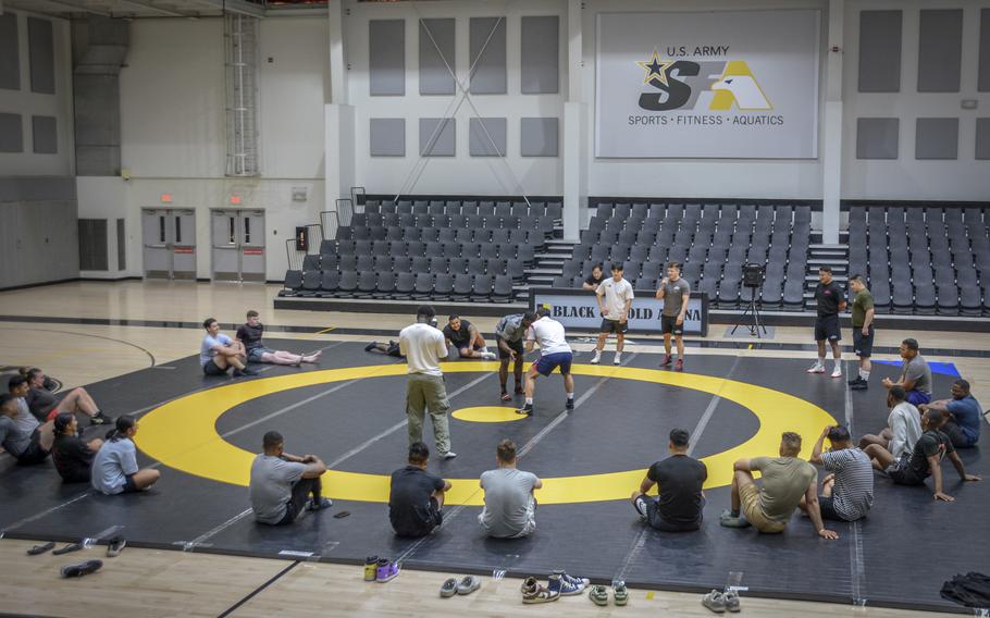 Service members gather for wrestling instruction seminar in Carey Fitness Center at Camp Caseys, South Korea, June 18, 2024.