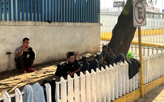 Migrants rest outside the bus station. MUST CREDIT: Mary Beth Sheridan/The Washington Post