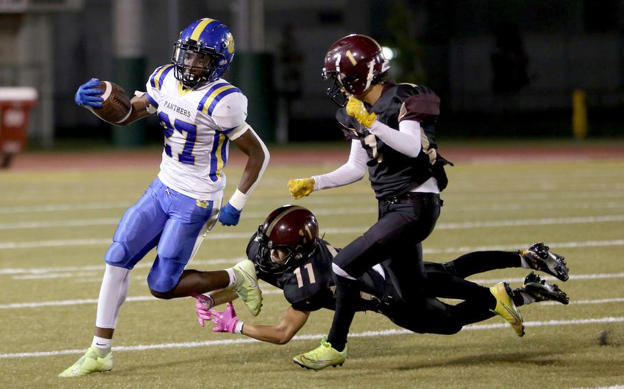 Yokota's A.J. Webster tries to evade two Matthew C. Perry defenders.