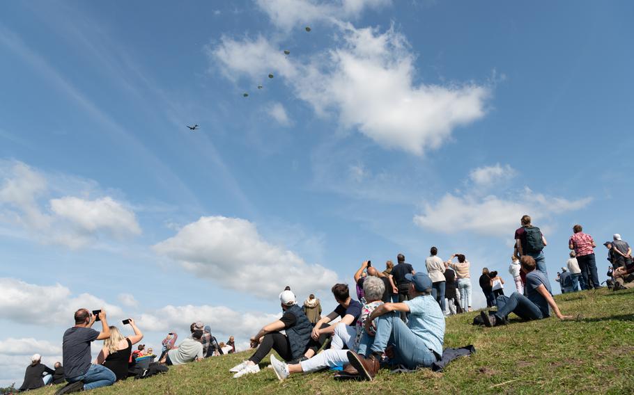 Spectators watch parachutists outside Eerde, Netherlands