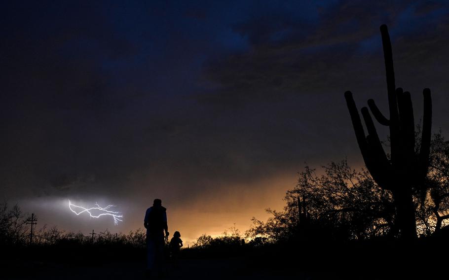 Lightning forms in the distance in Tucson, Ariz., July 28, 2023. 