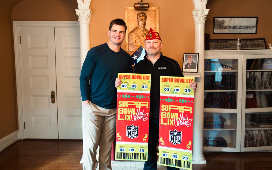 Drake Maye and Matt Jabaut pose with two Super Bowl tickets 