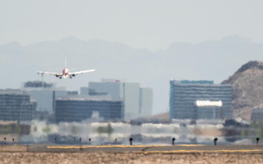 An airplane approaches the runway at the Phoenix Sky Harbor International Airport during a heat wave on July 15, 2023, in Phoenix, Ariz.