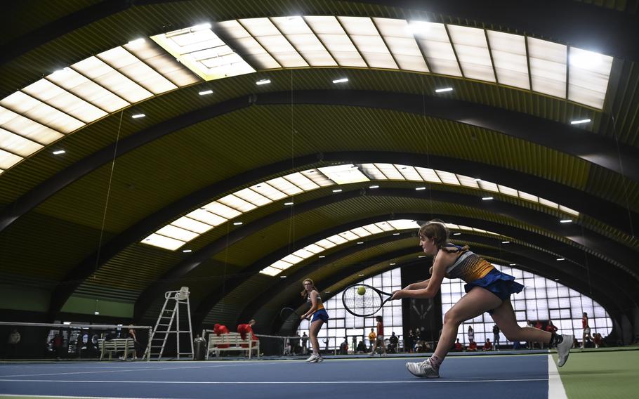 Wiesbaden's Samaire Fleming lunges with determination to reach a fast-moving ball during a doubles match, teaming with Bella Rainey, against Vicenza's Ava Parker and Sarah McGovern, at the DODEA European tennis championships at T2 Sports Health Club in Wiesbaden, Germany, on Oct. 21, 2023.