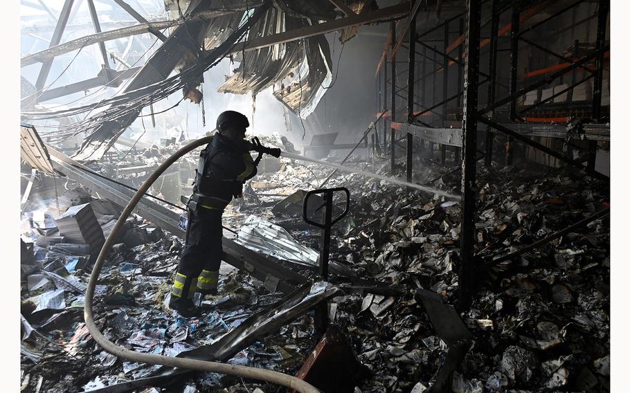 A Ukrainian rescuer works at the site of a missile attack in Kharkiv on May 23, 2024, amid the Russian invasion of Ukraine. Russian strikes on Ukraine’s second-largest city Kharkiv killed at least seven people, authorities said, as Moscow claimed fresh advances on the front line. 