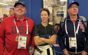 USA Olympic team leader Dwayne Weger, from left, Army Sgt. Sagen Maddalena and Olympic rifle coach Pete Durben await the final results of the qualification round of the women's 10-meter air rifle competition July 28, 2024, in Chateauroux, France.