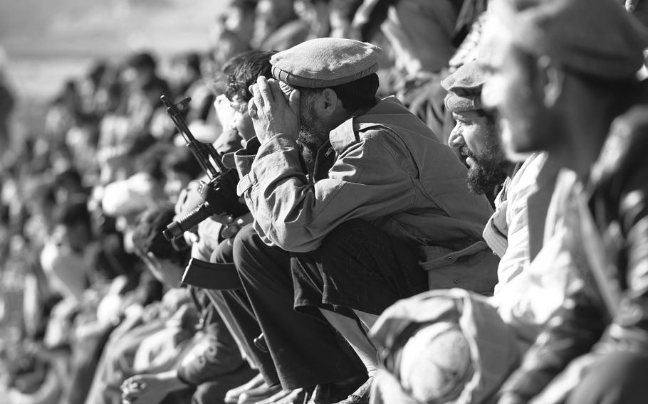 Crowds watch a buzkashi match on the outskirts of Kabul