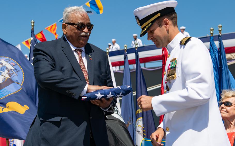 Commanding officer passes American flag