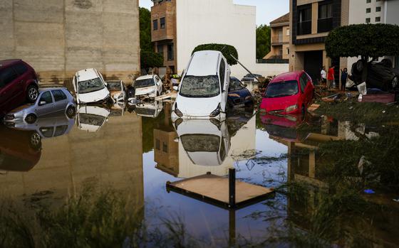 Flooded cars piled up are pictured in Valencia, Spain, Thursday, Oct. 31, 2024. (AP Photo/Manu Fernandez)