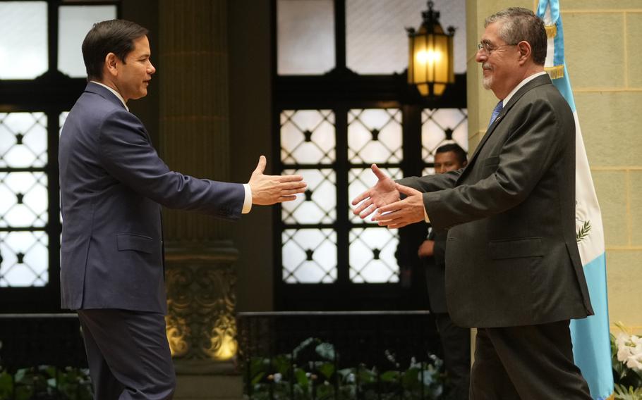 U.S. Secretary of State Marco Rubio, left, and Guatemalan President Bernardo Arevalo reach out to shake hands 