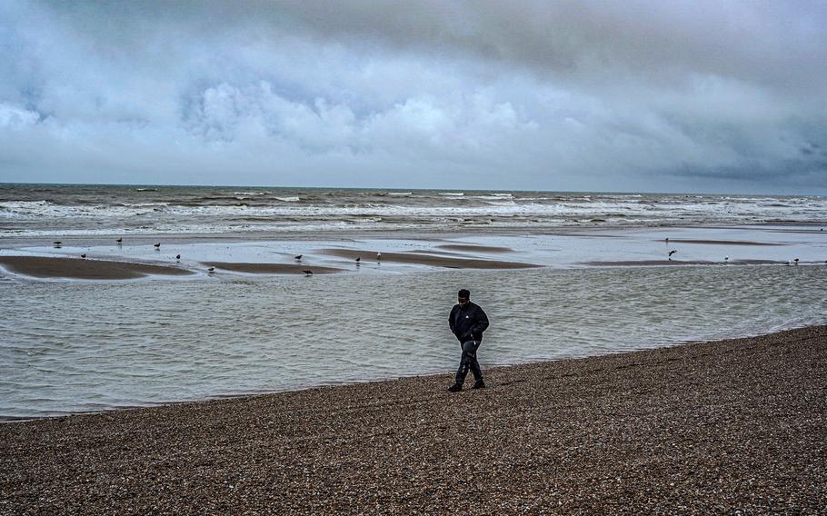 Bidias, a 32-year-old asylum seeker from Cameroon, walks along the beach in Hastings.