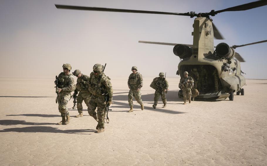 Soldiers walk away from a helicopter in Syria.