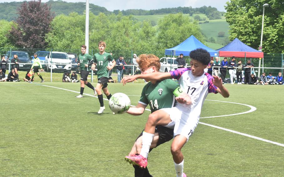 Naples' Camden Kasparek and Bahrain's Jesse Jones battle for the ball in a semifinal game at the DODEA European Division II boys soccer championships Wednesday, May 22, 2024, at Reichenbach-Steegen, Germany.