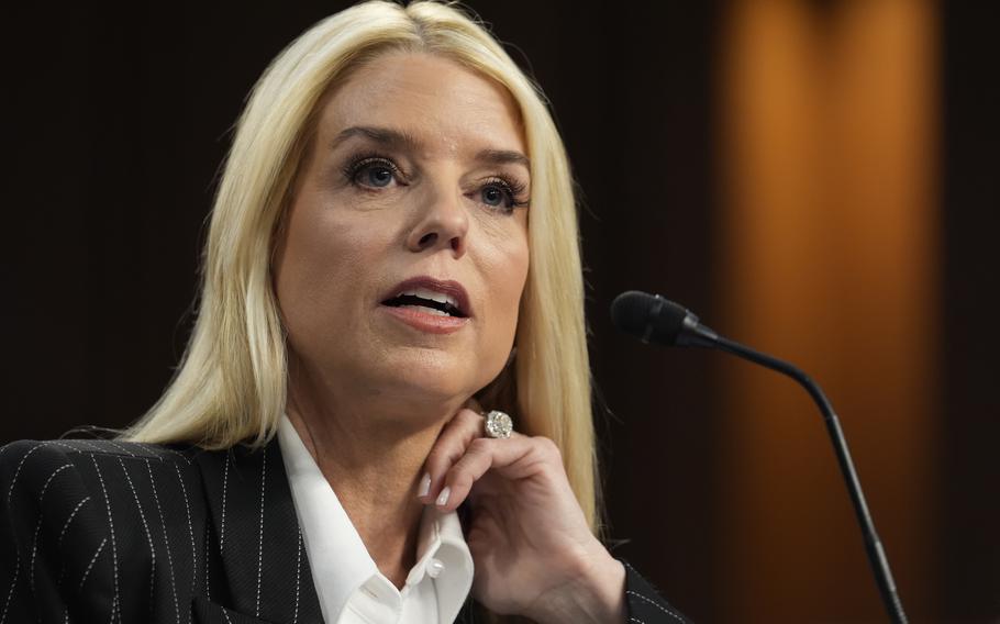 A woman with blonde hair speaks into a microphone during a congressional hearing.