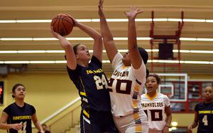 Ansbach's Kennedy Lange looks to shoot over Baumholder's Leai Vaisagote during a Jan. 24, 2025, contest at the Hall of Champions Physical Fitness Center in Baumholder, Germany.