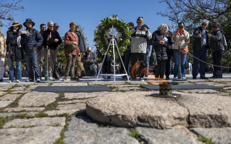 Members of the public photograph the gravesite of President John F. Kennedy at Arlington National Cemetery in Arlington, Va., on Oct. 17, 2024.