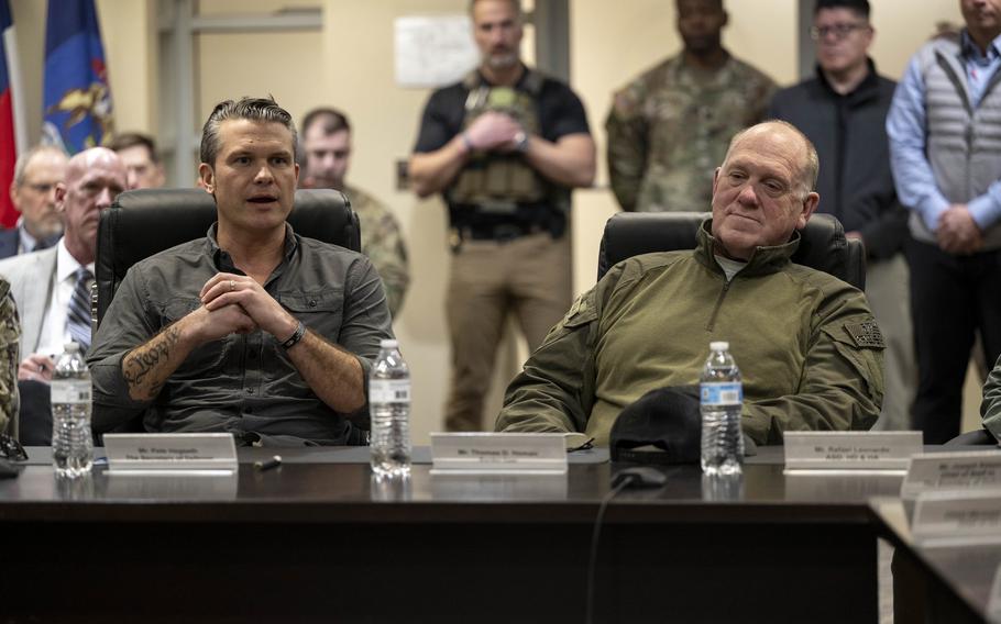 Hegseth sitting at a table.