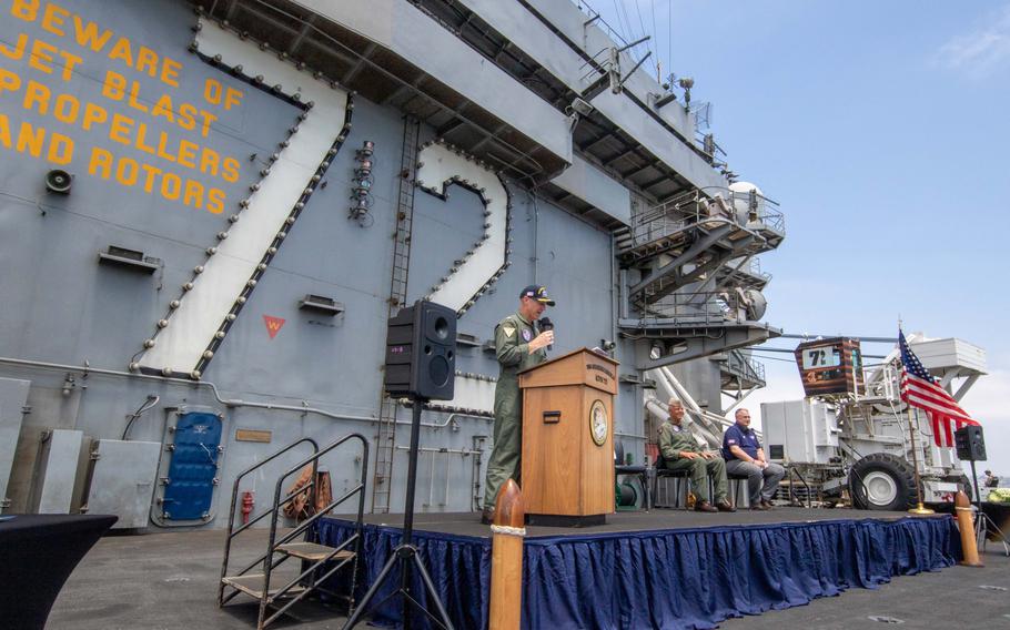 Capt. Pete Riebe, commanding officer of the Nimitz-Class aircraft carrier USS Abraham Lincoln, delivers remarks during a ribbon cutting ceremony to celebrate the opening of the USO Center aboard Abraham Lincoln. 