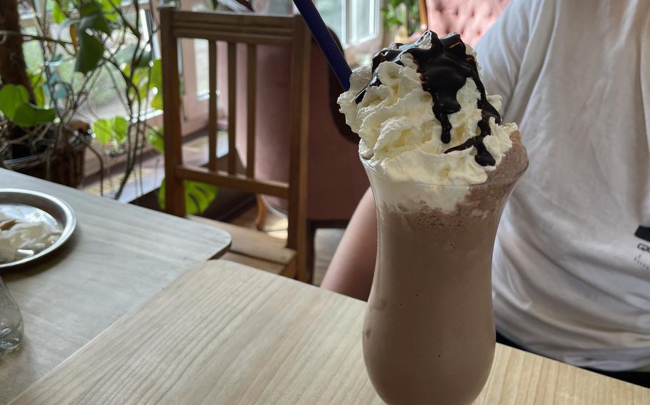A chocolate milkshake, heaped with a mound of whipped cream, at the Corner Cafe in Otterbach, Germany, on June 12, 2024.
