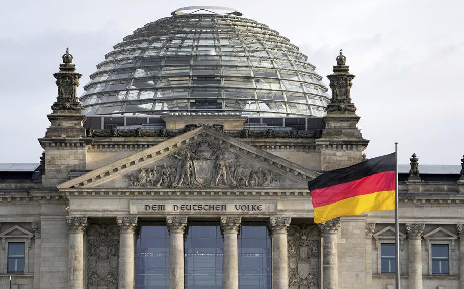 A national flag of Germany waves in front of the Reichag building, home of the German federal parliament Bundestag, in Berlin, Germany, on Jan. 3, 2022. 