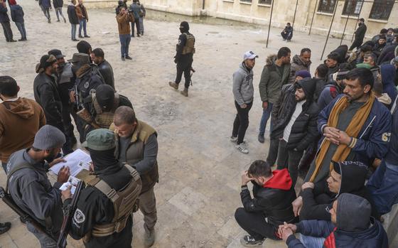 Men line up in a plaza.