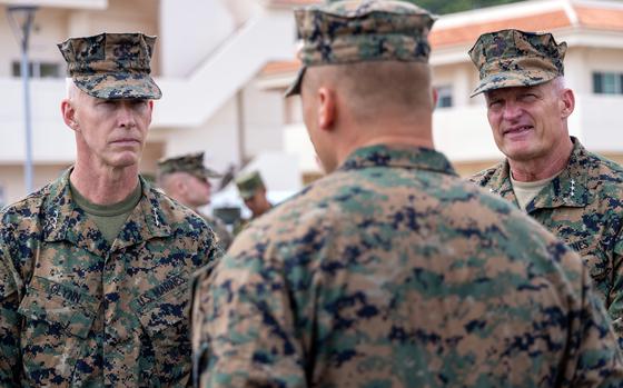 Lt. Gen. James Glynn, left, commander of Marine Forces Pacific, and Lt. Gen. Roger Turner, right, head of III Marine Expeditionary Force, speak to a Marine on Japan's Ishigaki Island, Oct. 23, 2024. 