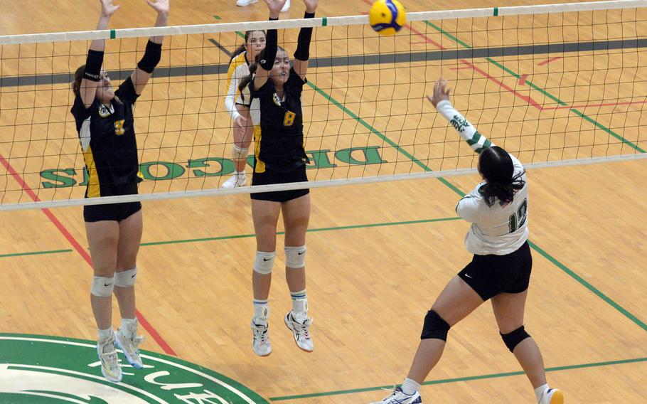 Kubasaki's Ayeli Rocha spikes against Kadena's Jenna Cook and Sara Mei Fussinger during Tuesday's Okinawa girls volleyball match. The Panthers won in five sets.