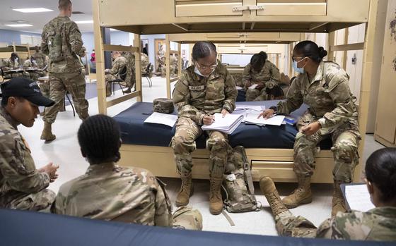 FILE - Students enlisted in the new Army prep course work together in barracks at Fort Jackson in Columbia, S.C., Aug. 26, 2022. The Army will expand its basic combat training for newly enlisted soldiers in what its leaders hope reflects a turning point as it prepares to meet the challenges of future wars. The added training will begin in October 2024 and comes as the Army works to reverse several years of dismal recruiting when it failed to meet its enlistment goals.  (AP Photo/Sean Rayford, File)