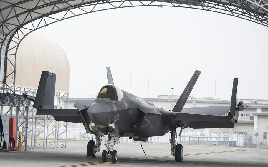 A fighter aircraft is parked in a hangar.