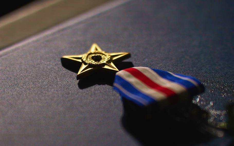 A Silver Star medal is displayed before being awarded.