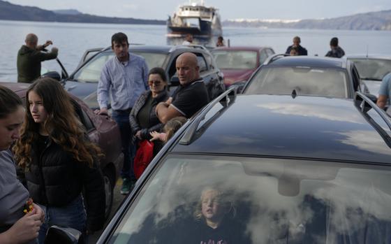 People wait for the arrival of a regularly scheduled ferry to Athens' port of Piraeus, after a spike in seismic activity raised concerns about a potentially powerful earthquake in Santorini, southern Greece, Monday, Feb. 3, 2025. (AP Photo/Petros Giannakouris)