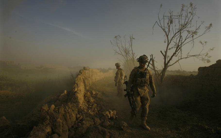 Platoon Leader 2nd Lt. Timothy Gonski, front, and Sgt. Frank Iannaccone of Company C, 1st Battalion, 32 Infantry Regiment, 3rd Brigade Combat Team, 10th Mountain Division, front, inspects a wall after blowing an anti-personnel obstacle breaching system.