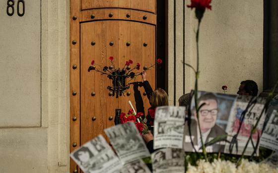 Red carnations are placed at the eastern entrance of La Moneda presidential palace on the anniversary of the 1973 military coup and President Salvador Allende's subsequent death in Santiago, Chile, Wednesday, Sept. 11, 2024. It was through this entrance that Allende's body was carried away 51 years ago and began the dictatorship of Gen. Augusto Pinochet. (AP Photo/Esteban Felix)