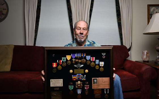 Dick Olson holds up a collection of medals, honors and other items he made into a display for his late father Major Richard Olson at his home in Westminster, Colorado on Jun 19, 2024. Dick Olson is the son of Richard Olson, a deceased WW2 veteran and Air Force Major. The elder Olson was injured in a B-24 plane crash in 1944 but never received a Purple Heart. The collection of medals of his father includes a Purple Heart but it is one Dick found to add to display saying that his father deserved it.  (Photo by Helen H. Richardson/The Denver Post)