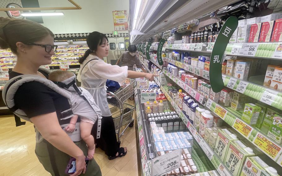 Akemi Kikugawa of the Japanese American Society helps Marine Corps spouse Camille Williamson shop at a Japanese grocery store near Marine Corps Air Station Iwakuni, Japan, Sept. 17, 2024.