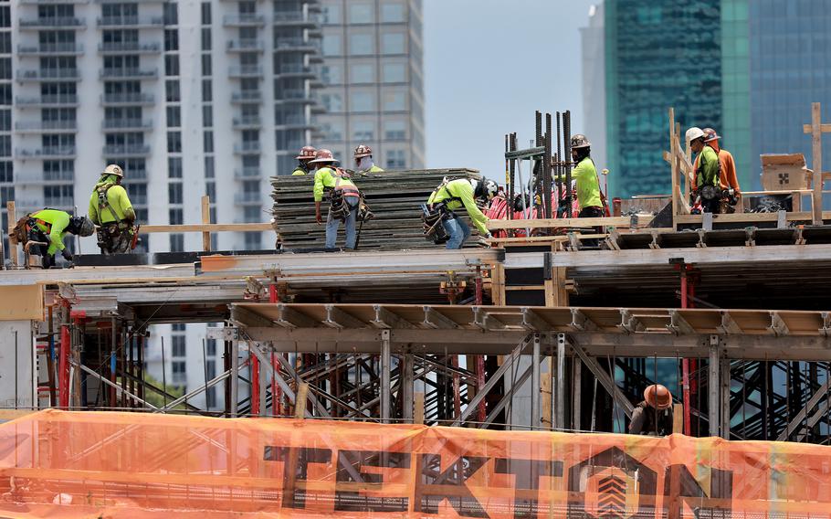 Construction workers on a job site on May 5, 2023, in Miami. 