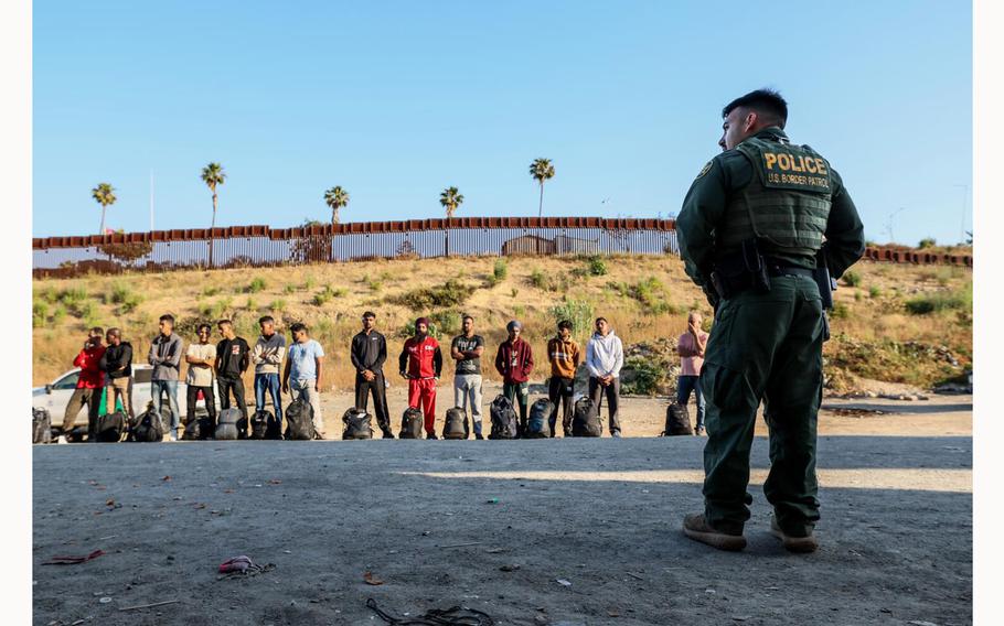 Dozens of people seeking asylum are detained by border patrol after crossing the US/Mexico border near San Diego, Calif., on June 5, 2024.