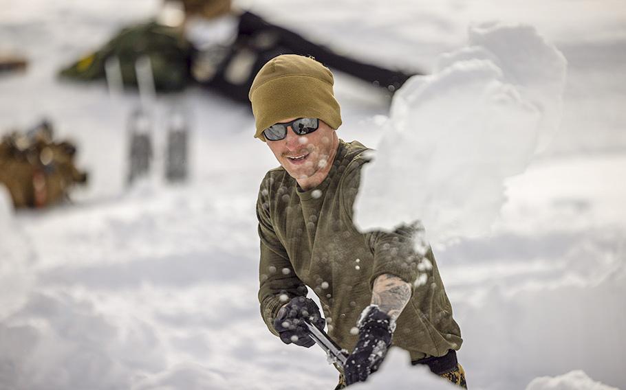 Petty Officer 2nd Class James Brewer shovels snow during a mountain warfare training exercise on Marine Corps Mountain Warfare Training Center in Bridgeport, Calif., on Jan. 27, 2023. 