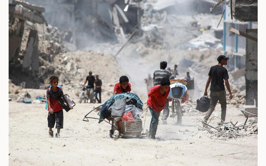 Displaced Palestinians return to Bani Suhayla and neighboring towns east of Khan Yunis following reports of Israeli forces withdrawing from the area in the southern Gaza Strip on July 30, 2024, amid the ongoing conflict between Israel and the Palestinian Hamas militant group.  