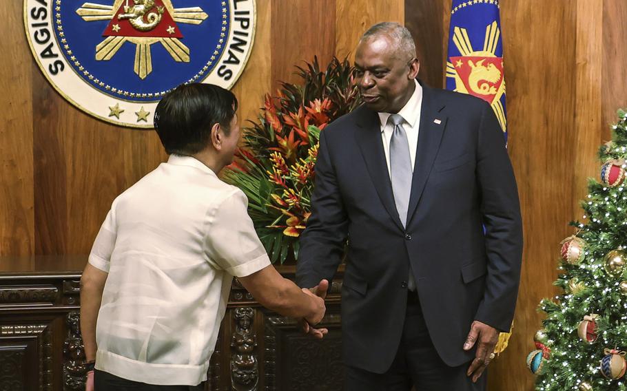 Philippines President Ferdinand Marcos Jr. shakes hands with U.S. Defense Secretary Lloyd Austin.