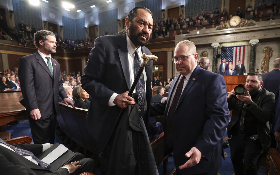 The sergeant at arms escorts Al Green out.