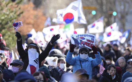 Supporters of impeached South Korean President Yoon Suk Yeol hold signs during a rally to oppose his impeachment near the Constitutional Court in Seoul, South Korea, Thursday, Feb. 13, 2025. (AP Photo/Lee Jin-man)