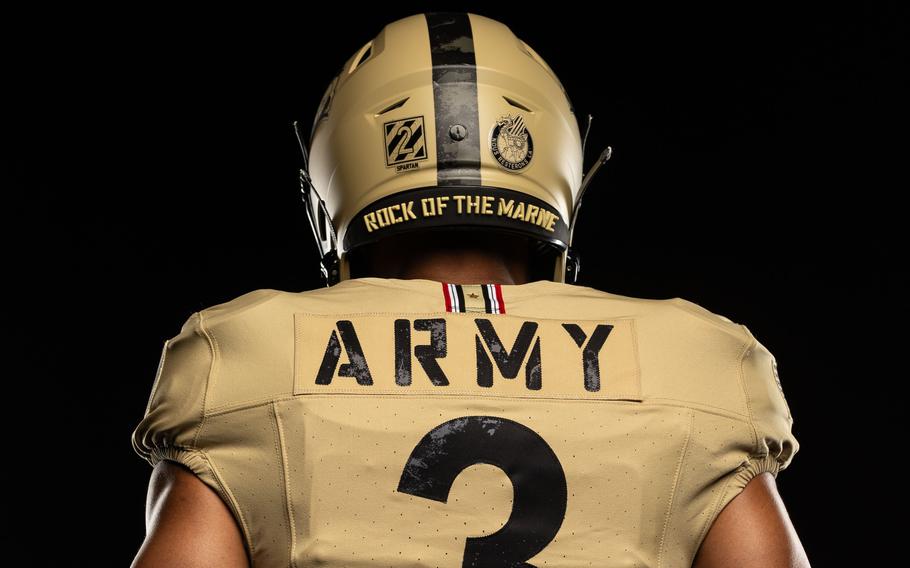 An Army player faces away to show the back of the jersey and helmet.